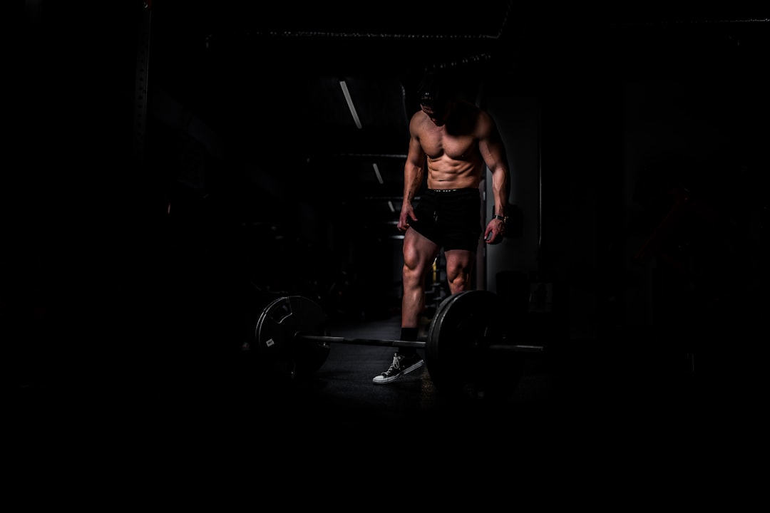 Progressive overload strength training with barbell and weights