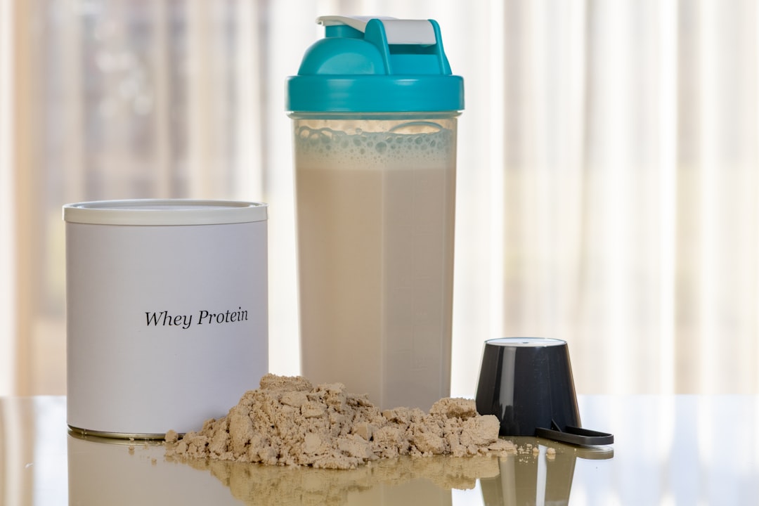Whey protein powder and scoop for muscle building and fat loss